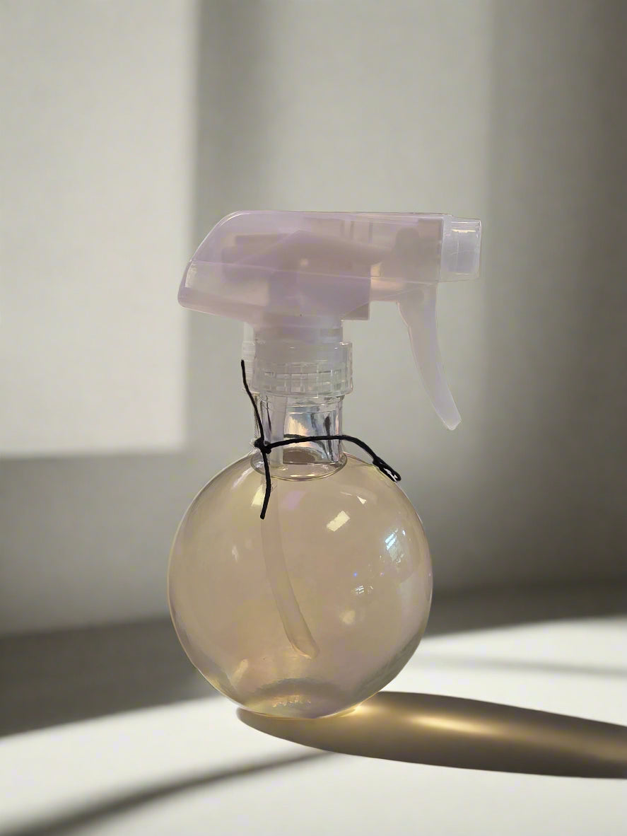 perfume bottle in a round glass bottle with a sprayer pump